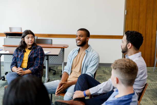 istock Diverse students and sponsor hold club meeting 1431383894