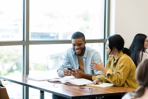 istock Young man surfs net to answer young woman's question 1431383915