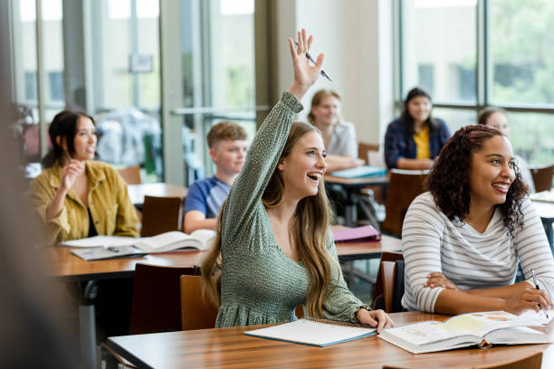 Young woman volunteers answer in class