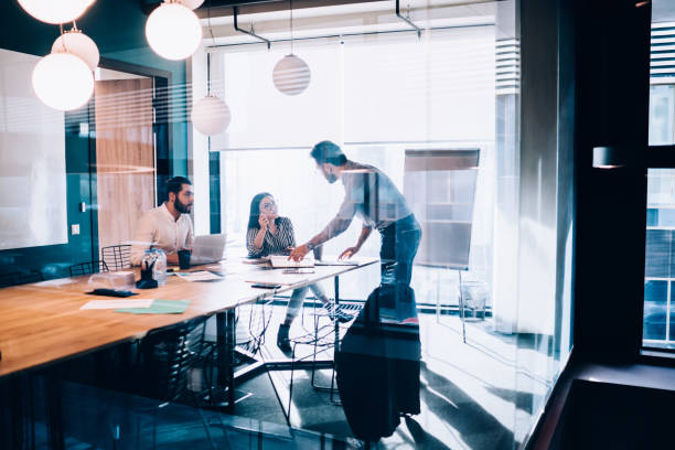istock Business people sharing ideas in conference room 1431384073