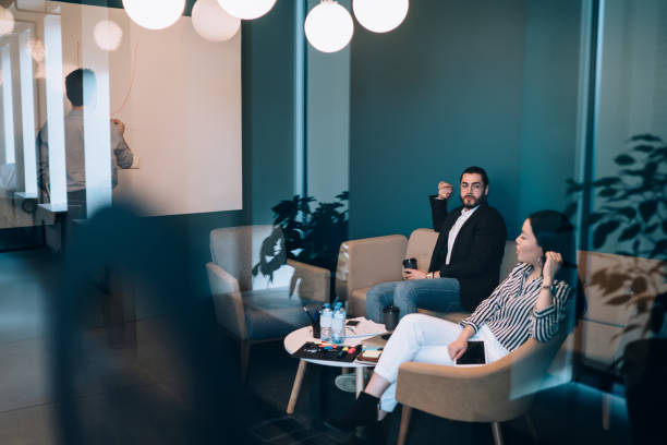 istock Business people discussing while writing on whiteboard at office 1431384089