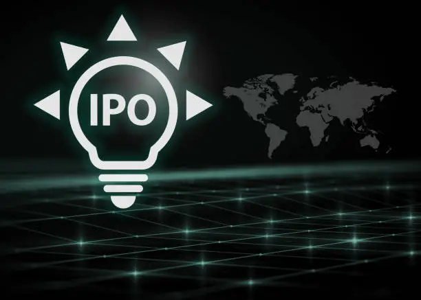 Photo of digital light bulb with IPO text on black background, trading, business and finance screen