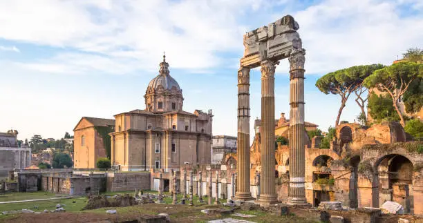 ROME, ITALY - CIRCA AUGUST 2020: sunrise light with blue sky on Roman ancient architecture.