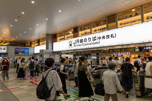 Osaka, Japan - August 17, 2022 : Passengers at the JR Tennoji Station in Osaka, Japan. It is a railway station on the JR West Osaka Loop Line, Hanwa Line, Yamatoji Line, Osaka Metro Midōsuji Line, and Tanimachi Line.