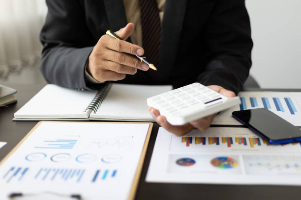 istock Businessman analyzes market statistical research reports and makes financial planning, investment accounting. 1431401804