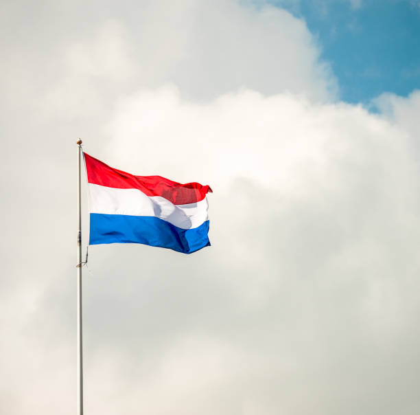 Dutch flag in a bright cloudy sky stock photo