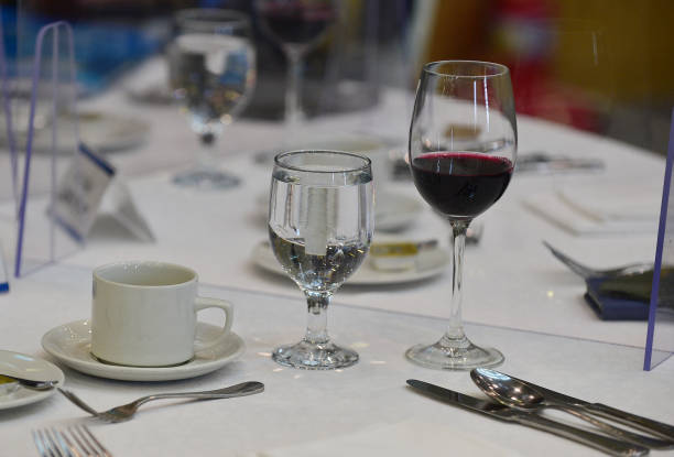 Wine and water glasses on the dining table stock photo