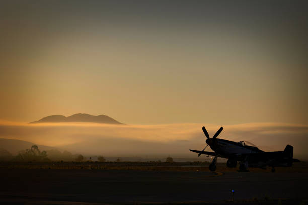 Mustang Morning Miramar, California, USA - September 25, 2022: The sun rises on a P-51 Mustang before the crowds arrive at the 2022 Miramar Airshow. p51 mustang stock pictures, royalty-free photos & images