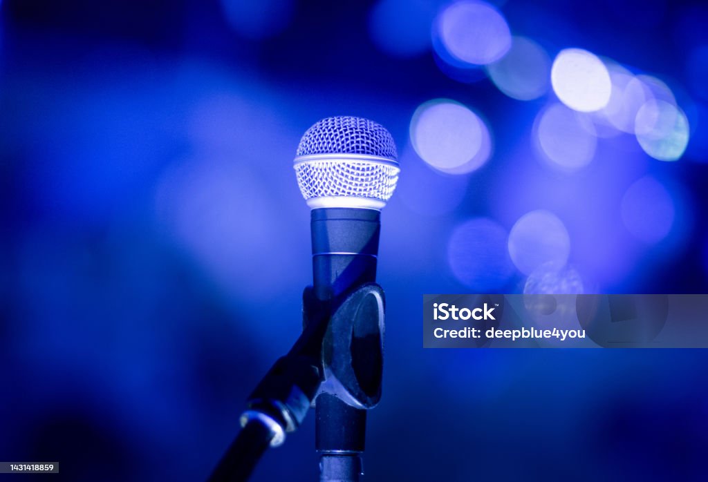 Microphone on the stage Microphone on the stage at the concert in the evening Aperture Stock Photo