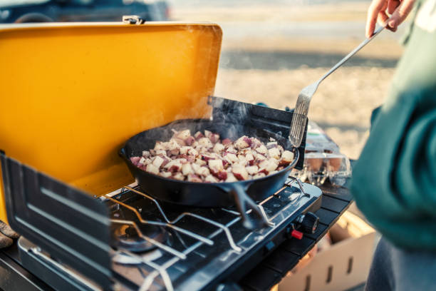 Preparing camp breakfast on gas stove at sunrise in Flaming Gorge, Utah, United States