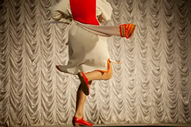 Photo of Girl dancing. Folk dance on stage. Dance lesson.