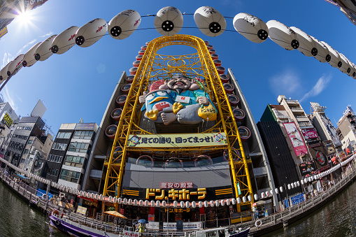 Osaka, Japan - August 19, 2022 : Don Quijote Store with the Ferris wheel in Osaka, Japan. It is a famous Japanese discount store chain.