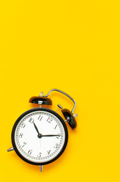 istock Black retro alarm clock on yellow background top view Flat lay copy space. Minimalistic background, concept of time, deadline, time to work, morning 1431424082