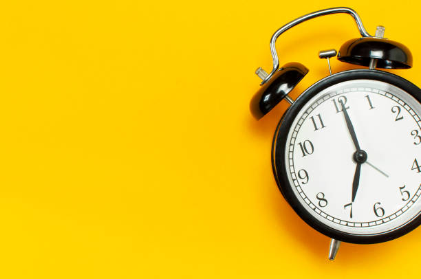 istock Black retro alarm clock on yellow background top view Flat lay copy space. Minimalistic background, concept of time, deadline, time to work, morning 1431424087
