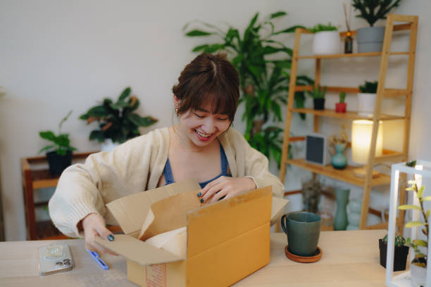 istock Asian woman scanning QR The code on the shipping box. 1431424434