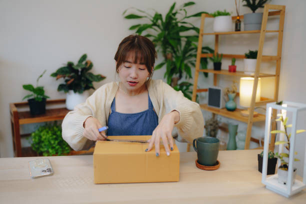 istock Asian woman scanning QR The code on the shipping box. 1431424440