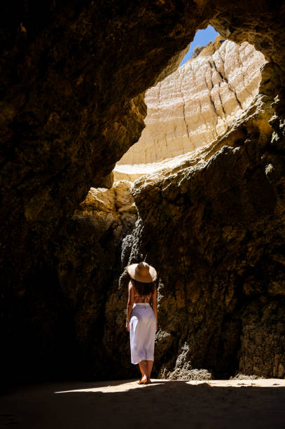 istock Unrecognizable female tourist standing in grotto 1431425476