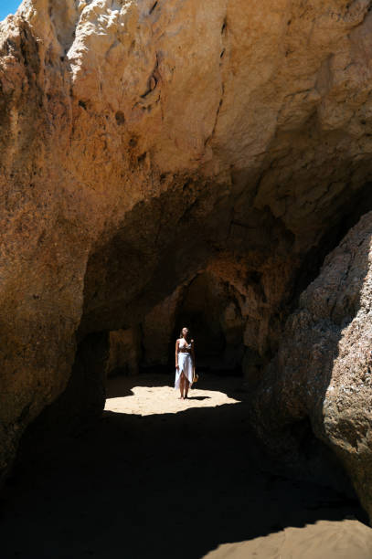 istock Happy woman in sunlit grotto in summer 1431425480