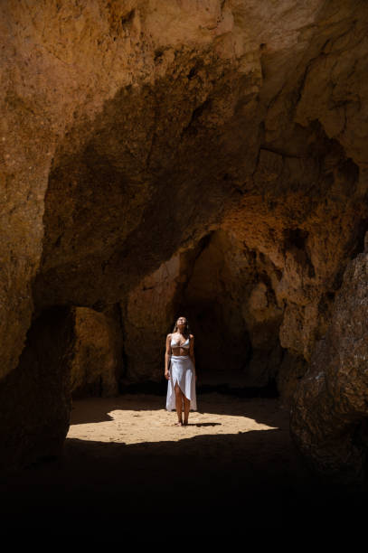 istock Happy woman in sunlit grotto in summer 1431425481