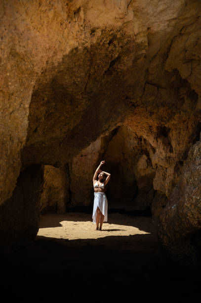 istock Happy woman in sunlit grotto in summer 1431425638