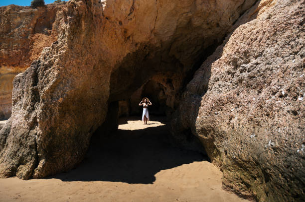 istock Happy woman in sunlit grotto in summer 1431425861
