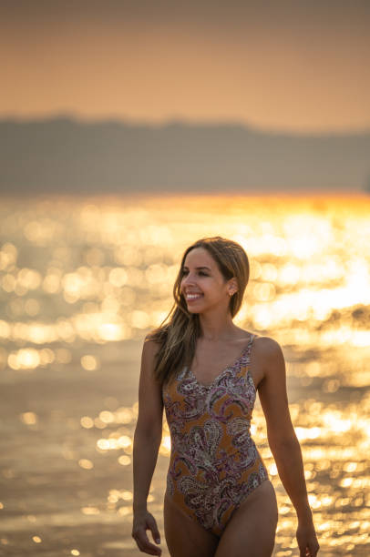 istock Happy woman walking on seashore 1431426842