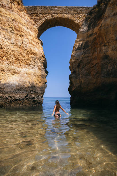istock Anonymous woman in sea near rocks 1431427414