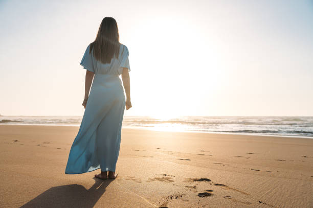 istock Anonymous woman admiring sea on sandy beach 1431429299