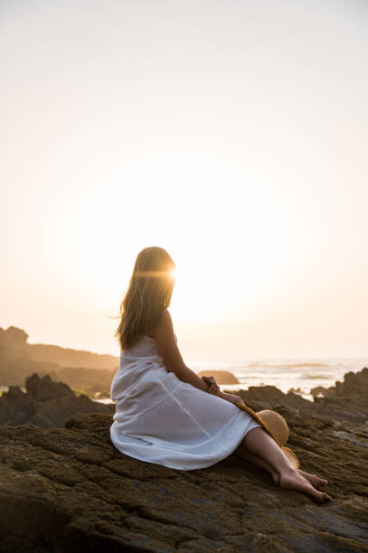 istock Unrecognizable woman on rocky seashore 1431429461