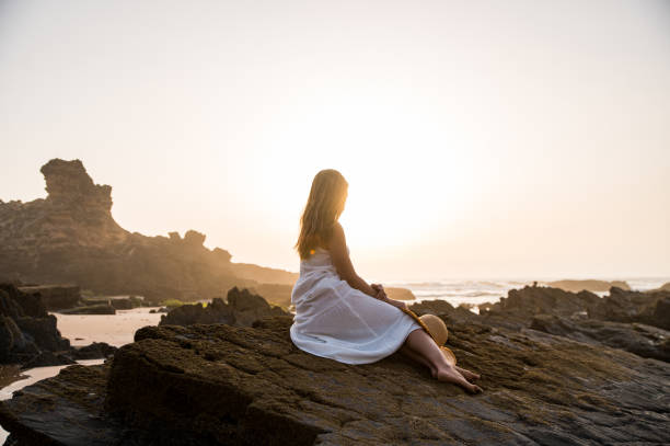 istock Unrecognizable woman on rocky seashore 1431429820