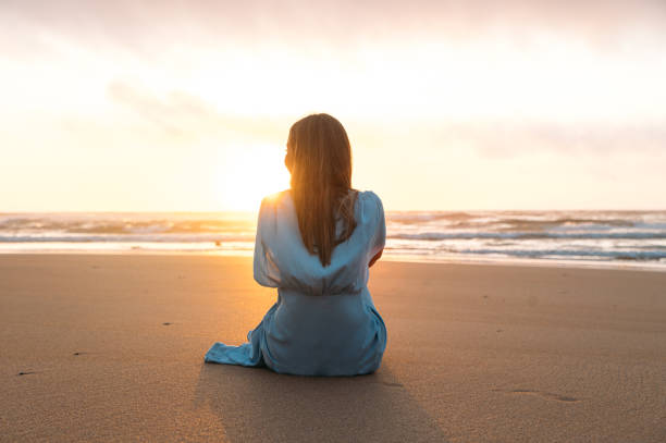 istock Unrecognizable woman admiring sea at sunset time 1431429841
