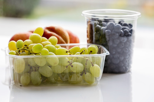 fruits in plastic containers: grapes, nectarines and blueberries