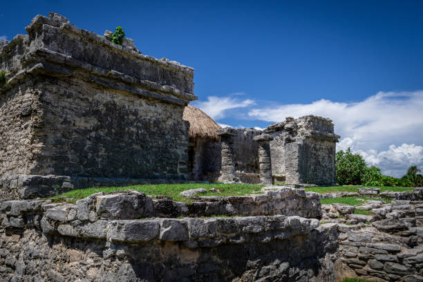 istock Tulum ruins Mayan site with temple ruins pyramids and artifacts in the tropical natural jungle forest palm and seascape panorama view in Tulum Mexico. 1431440465