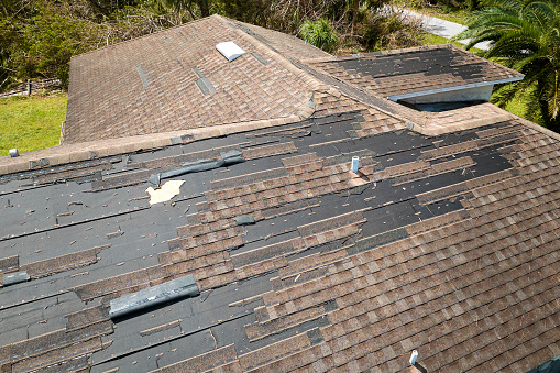 Pile of shingles laying on tarp during a roof replacement
