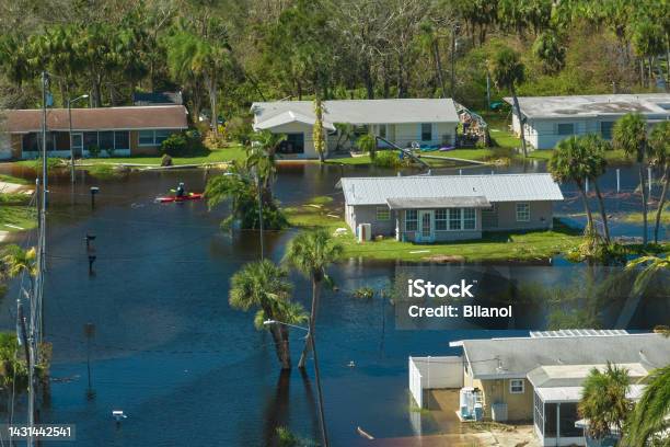 Surrounded By Hurricane Ian Rainfall Flood Waters Homes In Florida Residential Area Consequences Of Natural Disaster Stock Photo - Download Image Now