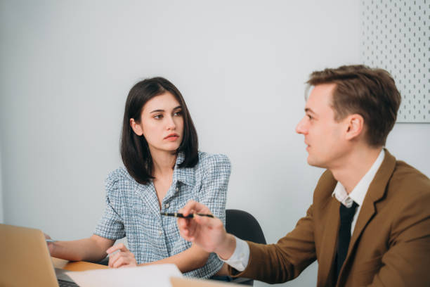 istock Businesspeople converse during a meeting about papers and concepts. 1431444733