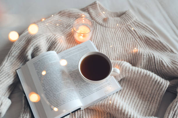 istock Cup of coffee with knit textile and lights 1431447312