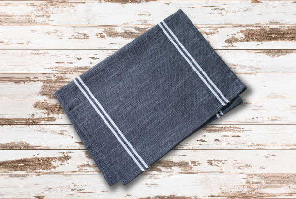 istock Folded towel, linen tablecloth on wooden desk top view. 1431450567
