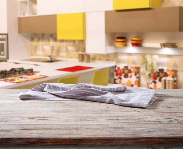 istock White napkin, table cloth on wooden deck mockup. Kitchen interior background 1431450597