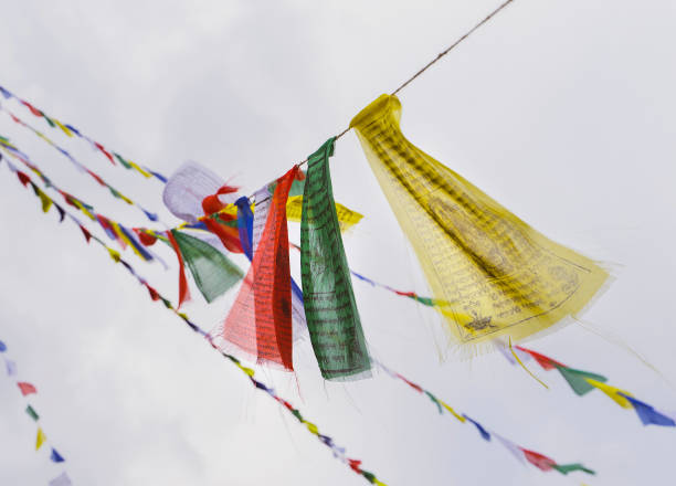 drapeaux de prière bouddhistes se balançant dans le vent contre le ciel. katmandou, népal. - tibetan buddhism photos et images de collection