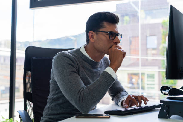 istock Young Latin man is in his office reviewing labor issues 1431456390