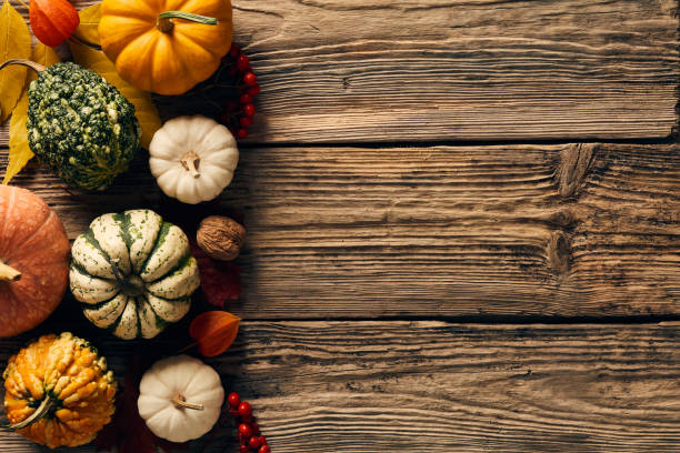 istock Autumn decorative pumpkins, gourds on wooden table. Top view, flat lay, copy space. 1431465212