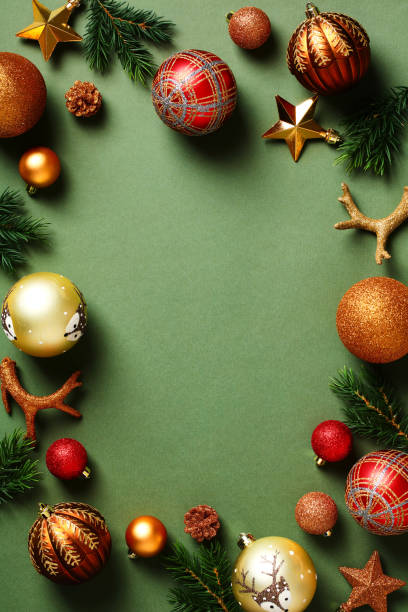 istock Vintage Christmas vertical background with festive baubles, fir branches, decorations on dark green background. Flat lay, top view, copy space. 1431466670