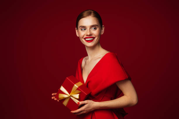 istock Beautiful emotional woman holding present box 1431468433
