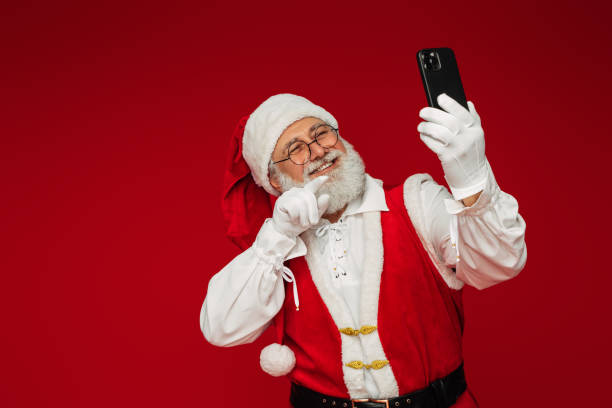 istock Happy, real, funny Santa Claus using smart phone 1431471497