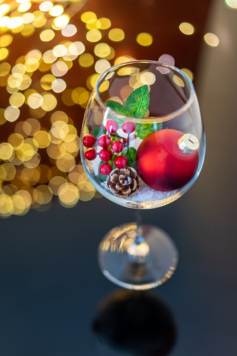 Stylish Christmas glitter baubles in wine glass. Merry Christmas and Happy New Year