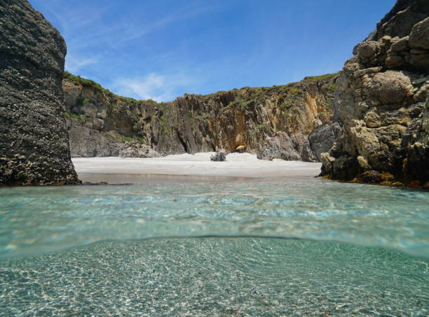 istock Secluded beach sea shore with sand and rocks Atlantic ocean Spain 1431476168