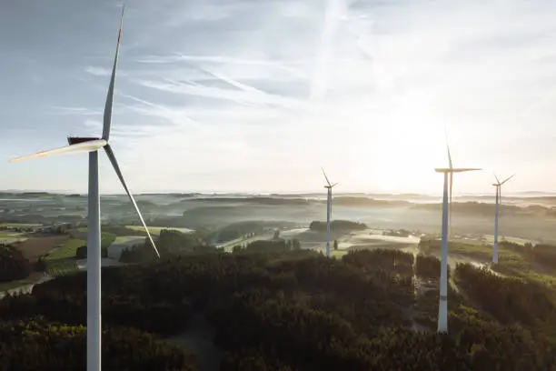 Photo of Wind turbine in the sunrise seen from an aerial view