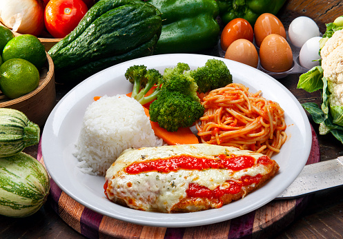 parmigiana steak with pasta, rice and vegetables,