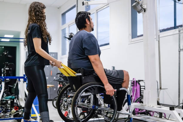 istock Man in wheelchair at physiotherapy 1431481039